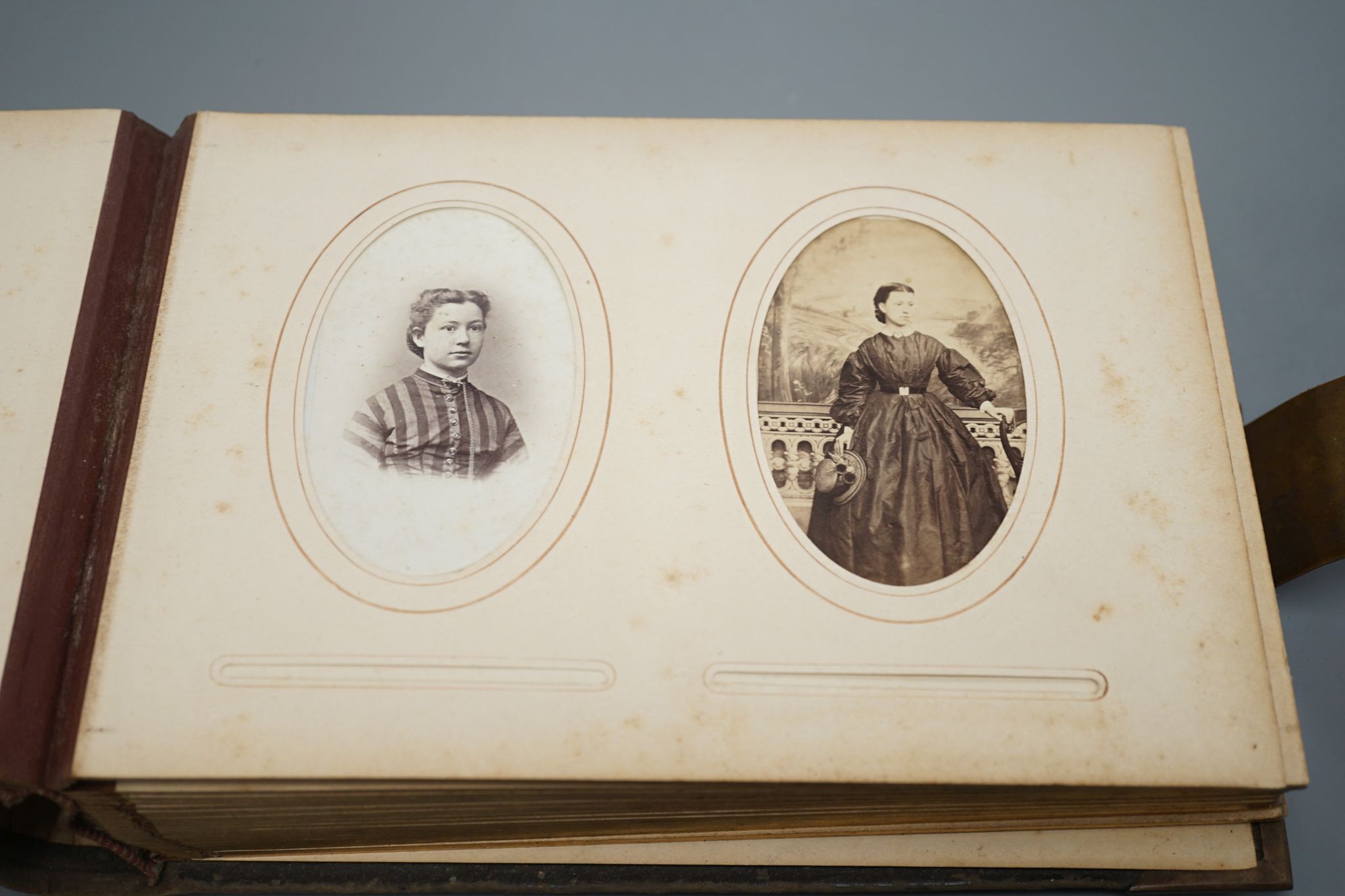 A collection of Victorian photographs etc including a tinted daguerreotype, three portrait miniatures and cabinet cards